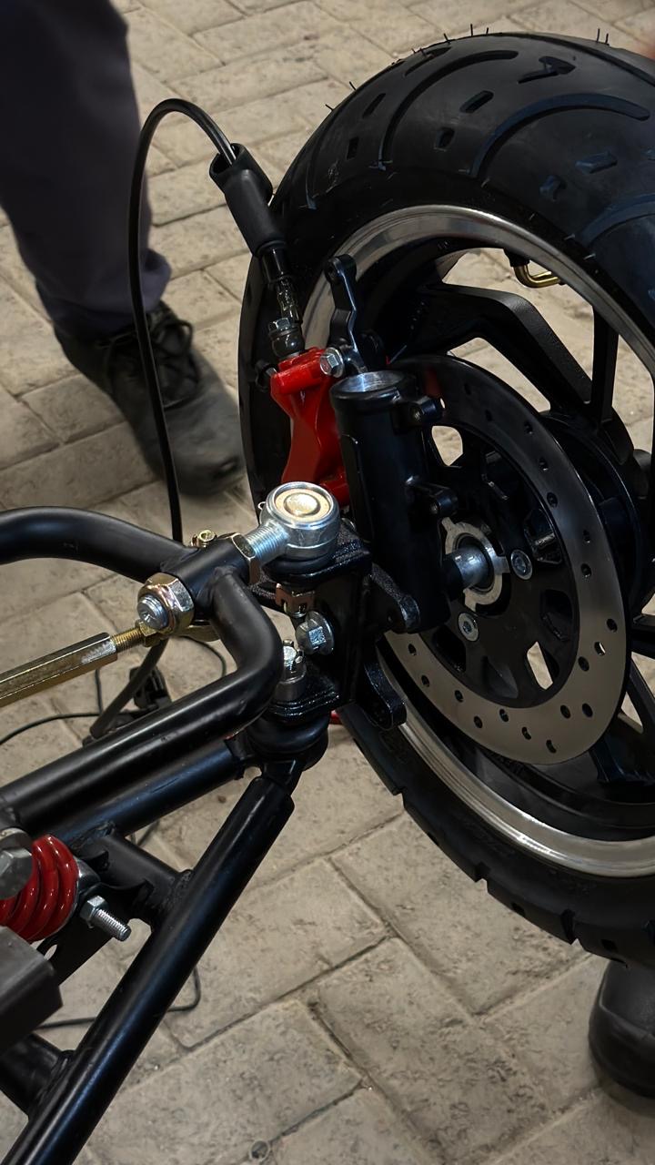 Disc brake, red caliper and steering knuckle at the front wheel